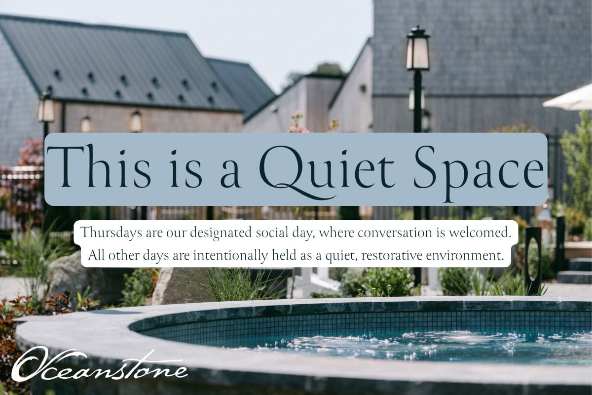 Tranquil courtyard with hot tub and modern buildings, offering a restorative spa retreat most days. Oceanstone Resort logo visible.